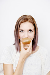 the girl holds the kiwi. A young woman holds a kiwi in her hands.