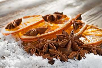 Obraz na płótnie Canvas Dried oranges slices with anise stars on wooden table