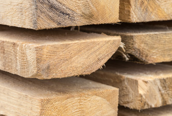 stack of thick boards new part of warehouse building material background texture with natural texture