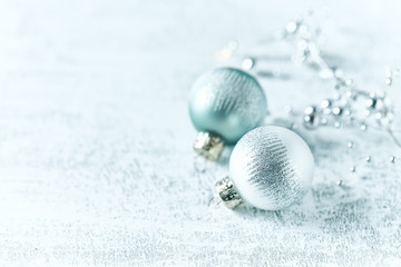 Silver and Blue Christmas Balls on white wooden background