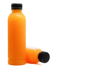 Bottles of fresh orange juice on white background with copy space, healthy drinking concept