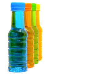 Colourful of sweet drinking water lined up in a vertical row on the left side of the white background