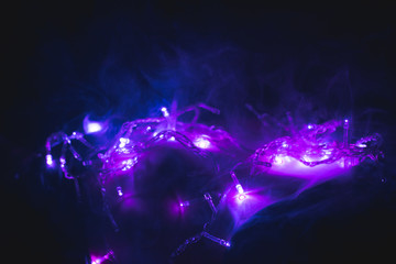 Obraz na płótnie Canvas Purple garlands in the smoke