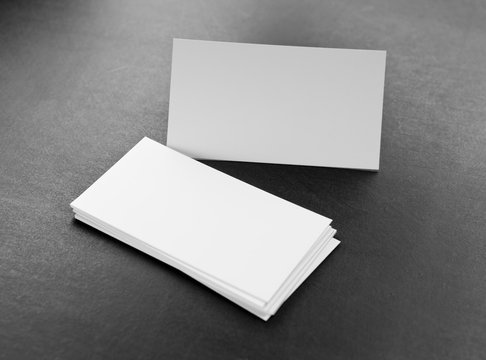 Blank business cards on a grey background