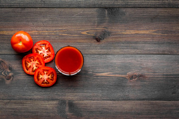 Red detox beverage with paprika and tomatoes on dark wooden background top view copyspace
