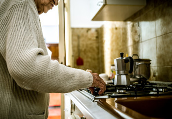 Old woman preparing coffee
