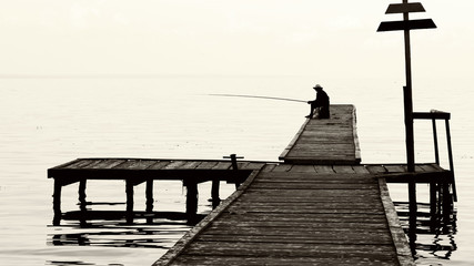 fisherman on the old bridge. photo