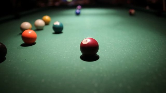 The beginning of a game of billiards with a breaking shot