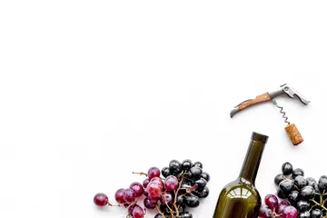 Poster Open the wine. Corkscrew near bottle and grape on white background top view copyspace © 9dreamstudio