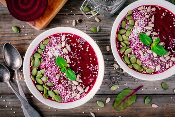 Beet smoothie bowl with chia seeds, coconut, pumpkin seeds, quinoa, sunflower seeds and mint