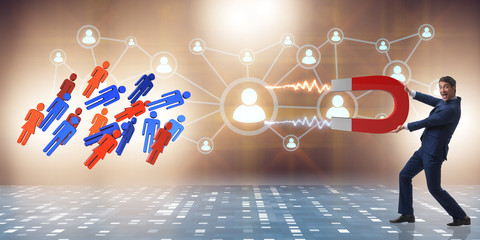 Businessman in recruitment concept with horseshoe magnet