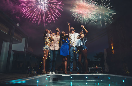 Group of friends having fun on the rooftop of a beautiful penthouse