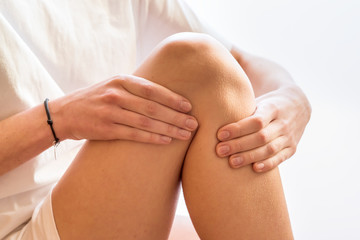 Woman with knee pain over white background.