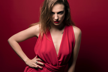 beauty girl with red dress in red background