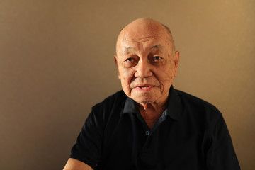 asian senior citizen portrait in room