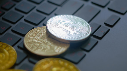 golden and silver bitcoins on keyboard