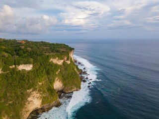 Aerial view of ocean rocky cliff near Uluwatu temple. Scenic landscape of fantastic view from drone. Bali, Indonesia.