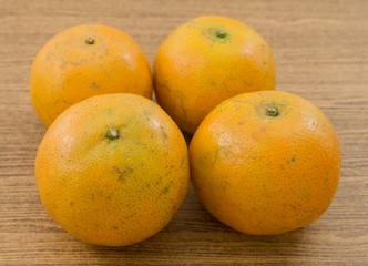 Four Fresh Oranges on A Wooden Table