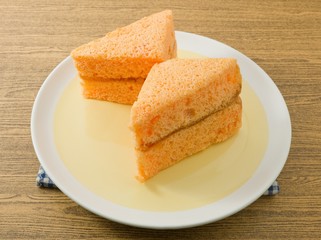 Two Triangle Orange Chiffon Cake on A Dish