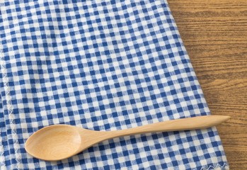 Wooden Spoon on A Blue Checked Towel