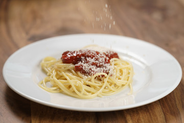 add grated parmesan on spaghetti bolognese