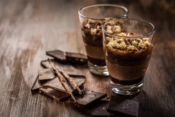 Gordijnen Layered chocolate dessert in a glass © Brebca
