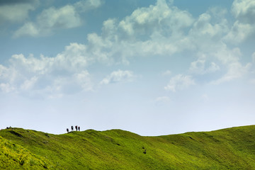 Fototapeta premium Hikers on the top of the ridge in the mountains