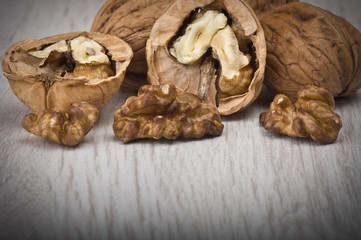 walnuts in shell and open on wood gray table