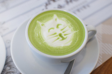 Hot coffee with foam milk art of cat.