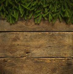 Christmas tree branches on wooden texture