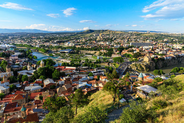Fototapeta na wymiar Panoramic view of Tbilisi city from the Narikala Fortress, old town and modern architecture. Tbilisi the capital of Georgia
