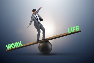 Businessman balancing between work and life in business concept