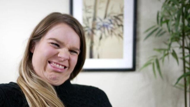 Brunette woman makes hilarious ridiculous goofy face 