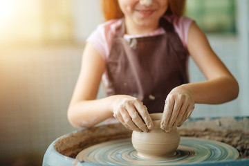 Hands of young potter, close up hands made cup on pottery wheel - obrazy, fototapety, plakaty