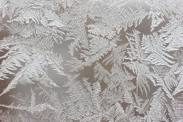 Frosty pattern on the window close-up. Winter background, texture