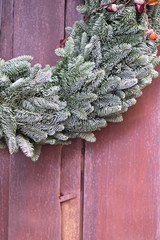 Fir tree wreath on wooden background. Christmas decoration.