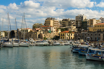 Fototapeta na wymiar HERAKLION, GREECE - November, 2017: colorful fishing boats and yachts in old Venetian fortress, Heraklion port, Crete