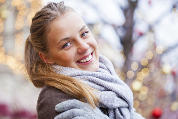 Young beautiful blonde woman in a brown coat