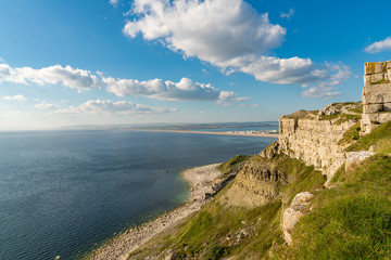 View from the South West Coast Path  towards Fortuneswell and Chesil Beach, Isle of Portland, Jurassic Coast, Dorset, UK - with clouds over Weymouth in the background