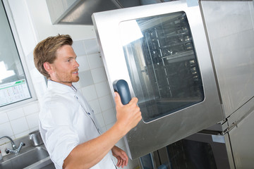man opening the big oven