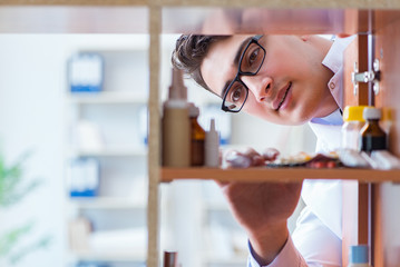 Doctor at farmacy retail shop looking for medicines