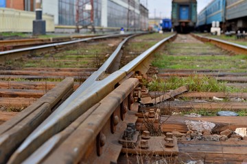 Railway station against beautiful sky at sunset. Industrial landscape with railroad, colorful...