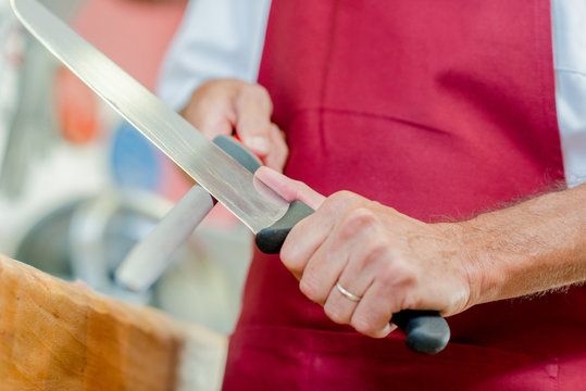 man sharpening a knife