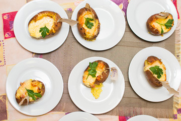 children learn how to cook stuffed potatoes in class