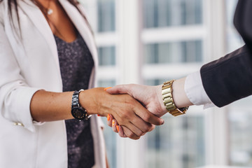Close-up of businesswomen shaking hands greeting each other before meeting