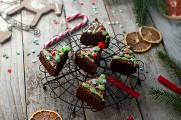 Christmas food ides, delicious chocolate brownies in shape of christmas fir tree on rustic wooden background