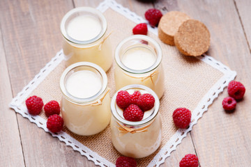 Jars with yogurt and raspberries 