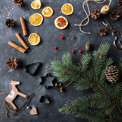 Naklejka premium Christmas flat lay home decor, dry oranges, fir tree, cinnamon and cones