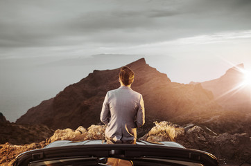 Relaxed businessman resting and watching the sunset