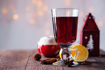 Hot mulled wine with spices and candlestick 